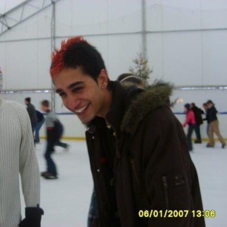 Sats is laughing because he's ice skating and is sporting a bright red mohawk